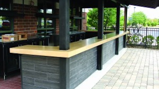 This precast outdoor bar countertop by Fishstone Studio was designed in five pieces to accommodate the shape and existing support poles.
