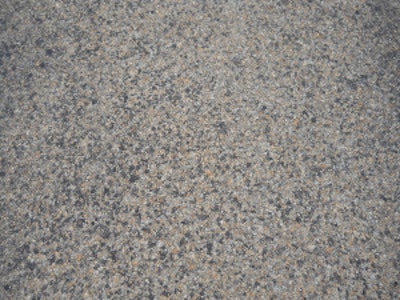 A close-up of the highway's three-course surface treatment that included the use of CRS-2P, a cationic rapid setting type of emulsified asphalt modified with the addition of polymers, and expanded clay lightweight aggregate (LWA).