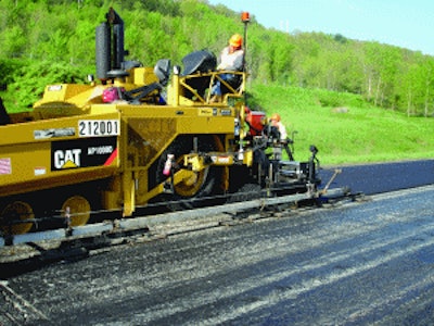 A 30-foot multi-articulated averaging ski is installed on the left side of the paver, with first pull truing and leveling over the rough PCC surface.