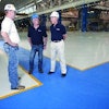 The management team at Healy, Long & Jevin stands on a recently completed industrial floor project where the company's place and finish crew installed superflat floors by hand, reaching FF and FL numbers well beyond specifications.