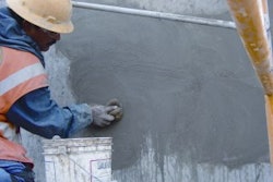 Rubbed finishes (free of bugholes) consist of either smooth-rubbed, grout-cleaned rubbed or cork-floated finishes. Here a worker is producing a grout-cleaned finish free of bugholes by rubbing a grout into the surface voids.