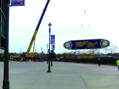 Dawes Rigging & Crane Rental lifted the 15,000-pound, 15 x 75-foot sign and its 17,000-pound steel framing from its place above the current scoreboard to make room for a new state-of-the-art scoreboard.