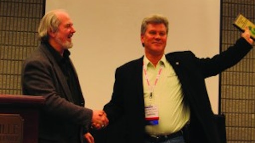 Ray Confer (right), president of C&J Parking Lot Sweeping, Warren, MI, accepts the 2011 WorldSweeper.com Award of Excellence in Power Sweeping from Ranger Kidwell-Ross, editor of WorldSweeper.com.