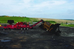 Mark Pahl with Dem-Con Shingle Processing uses a grinder designed specifically to process shingle material. The raw asphalt shingles are first ground to under a 1/2-inch minus size, and that material is then fed to a trommel to reduce the ground shingle material to an even finer size.
