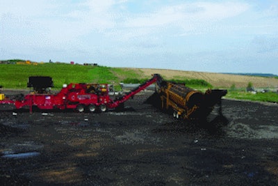 Mark Pahl with Dem-Con Shingle Processing uses a grinder designed specifically to process shingle material. The raw asphalt shingles are first ground to under a 1/2-inch minus size, and that material is then fed to a trommel to reduce the ground shingle material to an even finer size.