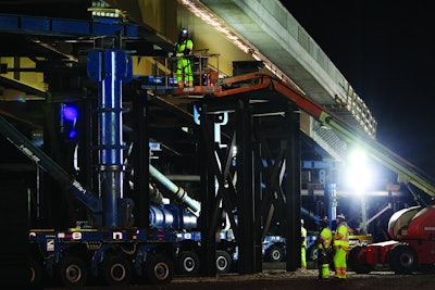 The self-propelled modular transporters - hydraulic jacks on wheels, controlled by a single joystick - were used to lift the 354-foot, 3.8 million-pound structure 21 feet in the air.