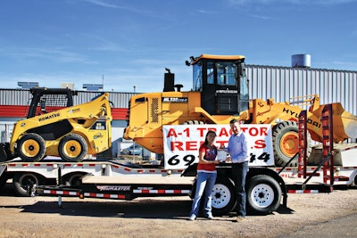 Arin Laugtug, Towmaster regional sales manager, gives Brook Hinman of A-1 Tractor, Kingman, Ariz., a Model TE-12D 12,000-lb. drop-deck trailer at The Rental Show.