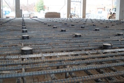 The structural slab-on-deck at the University of Alabama's Department of Science and Engineering contained No. 9 rebar 6 inches top and bottom with No. 5 galloping stirrups every 12 inches.