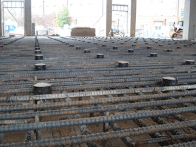 The structural slab-on-deck at the University of Alabama's Department of Science and Engineering contained No. 9 rebar 6 inches top and bottom with No. 5 galloping stirrups every 12 inches.