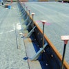 Metal forms are set in place at the Oakland International Airport prior to pouring one 40-foot-wide lane of an 18-inch-thick concrete apron. Forms were designed with a 4-1/2-inch extension that can be added to form a deeper perimeter.
