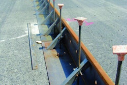 Metal forms are set in place at the Oakland International Airport prior to pouring one 40-foot-wide lane of an 18-inch-thick concrete apron. Forms were designed with a 4-1/2-inch extension that can be added to form a deeper perimeter.