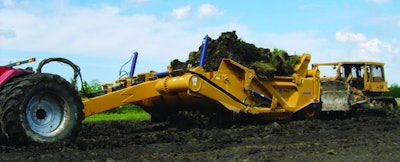 K-Tec's 1453 scraper hauls up to 53 cu. yds. Four 29-in. tires provide flotation.