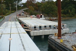First two spans of the Knickerbocker Bridge set in place with the third span in foreground on truck ready to be placed. The crew is preparing bearing seats.