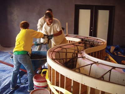 The crew at the Decorative Concrete Institute had to manually place concrete into a countertop form after a pump mishap.