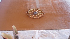 Recycling artists utilize materials that might otherwise end up in the landfill. We did some recycling art of our own by embedding a sprocket we found on our property in fresh concrete prior to polishing.