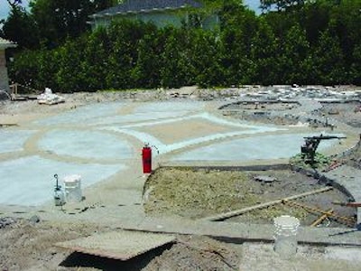 The 2,500-sq.-ft. courtyard was worked in sections outward from a central design. The separate pours are held together with steel dowels.