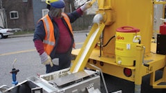 When the handliner is empty the operator returns to the melter and fills it up again. The advantage is one of productivity and efficiency as an operator or crew can put down much more material on the pavement when using melter kettles to heat it. Note the face shield.