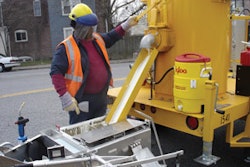 When the handliner is empty the operator returns to the melter and fills it up again. The advantage is one of productivity and efficiency as an operator or crew can put down much more material on the pavement when using melter kettles to heat it. Note the face shield.