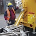When the handliner is empty the operator returns to the melter and fills it up again. The advantage is one of productivity and efficiency as an operator or crew can put down much more material on the pavement when using melter kettles to heat it. Note the face shield.