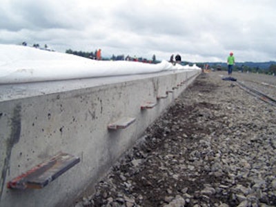 Steel plate dowels carry loads across a construction joint, maintain vertical alignment between adjacent slabs and allow concrete shrinkage both perpendicular and parallel to the joint.