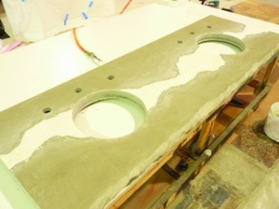 An in-progress shot of the bathroom vanity shows an uncolored countertop with a white micro topped vein and a engraved vein. The finished bathroom vanity.