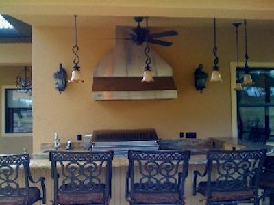 Before adding the concrete overlay the outdoor kitchen wall was plain with no artistic characteristics.