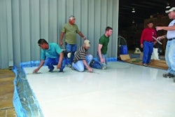 Mike Emma and Kurt Ziegler, kneeling on right, attended a skim coating class at the Decorative Concrete Institute four days after returning home from a tour of duty in Iraq.