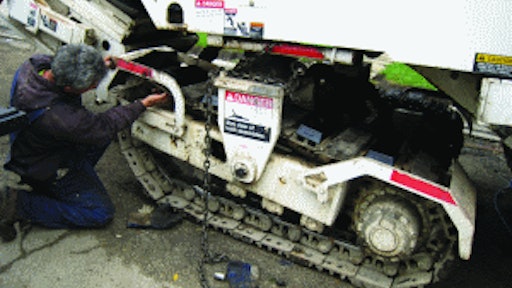 Bolt-on polyurethane track pads that mount over the triple grousers - such as these from BLS Enterprises - can save a lot of labor.