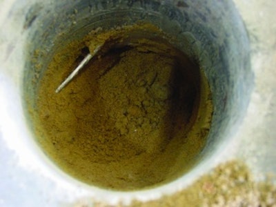 Reinforcement partially buried in the subbase does not provide crack width control. Without supporting chairs or pre-cast concrete blocks, reinforcement typically ends up in the bottom of the slab or buried in the subbase.