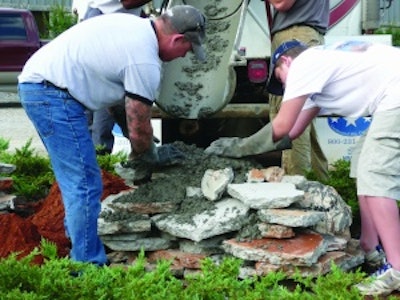 Bob Harris and son Robby Harris reuse concrete test slabs to create a foundation for a one-of-a-kind boulder.