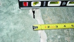 This out-of-joint floor crack was caused by excessive concrete shrinkage and joint spacing. Because of the wide crack width and curling, load transfer across this crack through aggregate interlock has been lost.