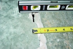 This out-of-joint floor crack was caused by excessive concrete shrinkage and joint spacing. Because of the wide crack width and curling, load transfer across this crack through aggregate interlock has been lost.