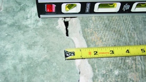 This out-of-joint floor crack was caused by excessive concrete shrinkage and joint spacing. Because of the wide crack width and curling, load transfer across this crack through aggregate interlock has been lost.