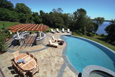 Rich Capachione, owner of New England Hardscapes, and his crew used their stamped concrete hybrid technique to create this a decorative concrete pool deck that mimics the appearance of flagstone and bluestone.