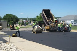 Another crew member followed the paver and the roller with a walk-behind compaction plate to ensure all edges along the sidewalk and parking lot were compacted properly.