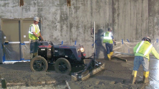 A Lindsay Lampasona crew uses a Somero Power Rake to verify subgrade tolerance before striking off a 20,000-square-foot floor at a Walmart in North Smithfield, R.I.