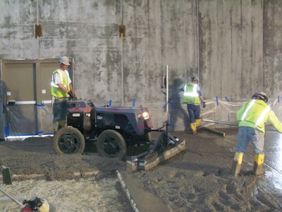A Lindsay Lampasona crew uses a Somero Power Rake to verify subgrade tolerance before striking off a 20,000-square-foot floor at a Walmart in North Smithfield, R.I.