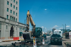 The smaller overall footprint and narrow swing radius of the Caterpillar wheel excavators proved ideal for Archer Western on the Valley Metro Rail Line project in downtown Phoenix. This image, taken through the windshield of a passing vehicle, demonstrates just how tight the work area actually was.