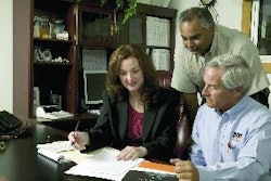 Lorie Waldrop, general manager, and Hikman Rahman, executive vice president, Terra Construction Group, go over a list of equipment destined for auction with Scott Linder, IronPlanet territory manager for Central Florida.