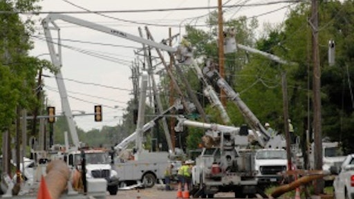 Repair crews work to clear the streets after numerous downed trees blocked traffic in the wake of a tornado that hit Carbondale, IL in 2008.