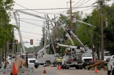 Repair crews work to clear the streets after numerous downed trees blocked traffic in the wake of a tornado that hit Carbondale, IL in 2008.