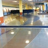 Two ribbons of color -- one black and one sepia -- wind throughout the floors of the Anchorage airport.