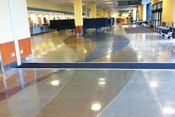 Two ribbons of color -- one black and one sepia -- wind throughout the floors of the Anchorage airport.