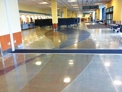 Two ribbons of color -- one black and one sepia -- wind throughout the floors of the Anchorage airport.