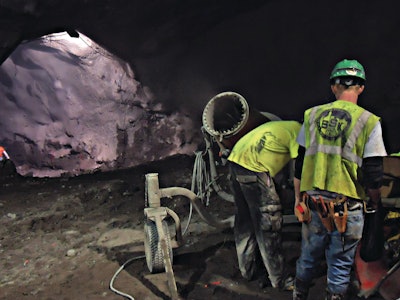 Workmen set up the DustBoss DB-60 on the blasting job for the 2nd Avenue Subway under Manhattan. Three of the machines, and one smaller unit, replace laborers with fire hoses, which would have cost the contractor up to $1 million per year on the job.