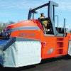 Accessories, like heat skirts, can be used to keep the tires hot to prevent material pickup.