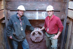 ICON Tunnel Systems' Rob Langenbach, operations manager and chief operator, and Dan Paster, national guided auger boring consultant and operator, stand in the receiving pit next to the Front Steer Boring Head.