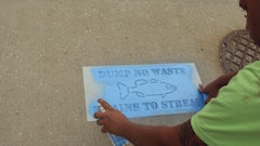 As a volunteer part of Missouri's Dept. of Conservation Stream Team Gann Asphalt alerts the public to deter use of storm drains as disposal sites.