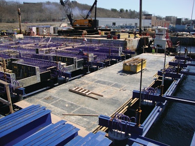 The pier is constructed of a complex honeycombed cast-in-place concrete substructure of pile caps, duct banks and mechanical chases and will be topped with a cast-in-place concrete deck.