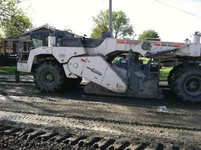 After milling off 3-4 inches of the existing surface, Midwest Stabilization used a Wirtgen 2400 reclaimer to till the cement into the surface.